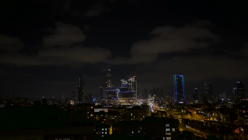 Modern City at Night with Glowing Skyscraper Lights
