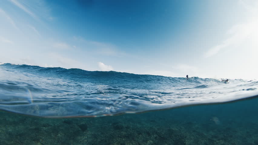 Underwater view of the ocean wave breaking over the shore in the Maldives