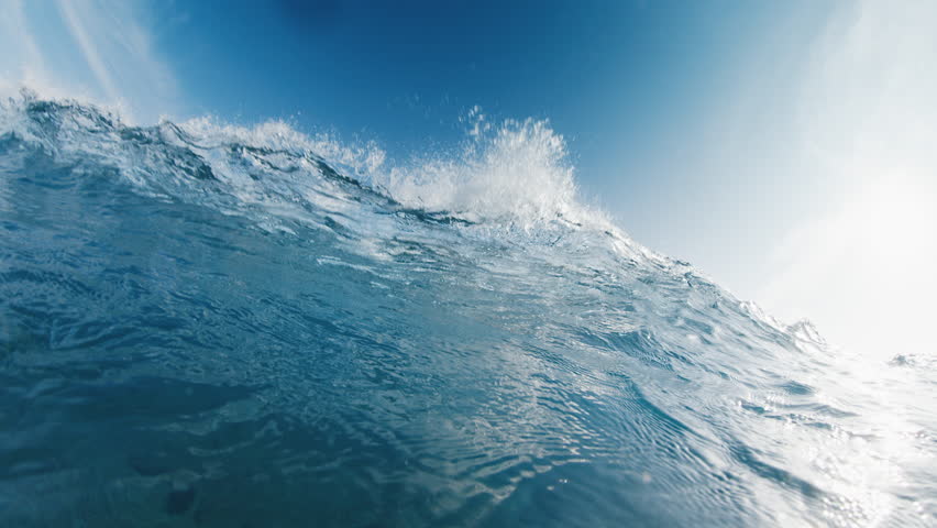 Underwater view of the ocean wave breaking over the shore in the Maldives