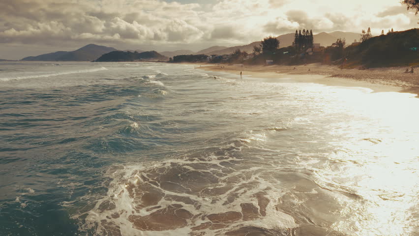 Aerial view of the Brazilian coast with sandy beach living buildings and wavy Atlantic Ocean. Florianopolis, Santa Catarina