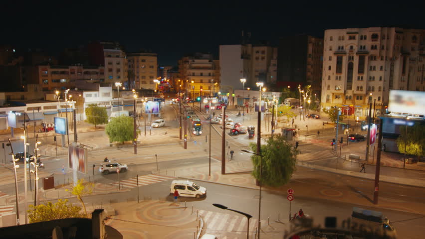 Night timelapse of the city of Casablanca in Morocco. Night street timelaspe of the square filed with cars, trains and pedestrians in Casablanca, Morocco