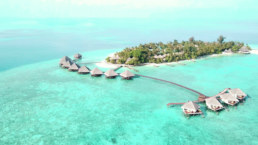 Drone Shot of Small Island in Maldives, Luxury Tropical Resort With Bungalows Over Turquoise Water
