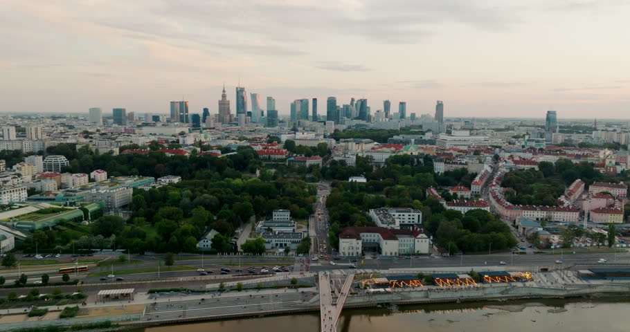 Aerial view of Warsaw cityscape with a distant Downtown Skyline. Typical Urban panorama with Polish Landmarks, ideal for establishing scenes, travel and European capital city visuals. 4K drone shot 