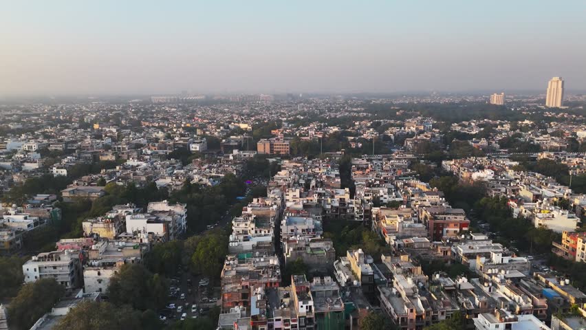 An aerial view of the tricolour standing tall in the heart of Delhi, Bridge fluttering proudly over busy roads and compact residential blocks—an iconic symbol of India’s spirit and sovereignty.