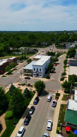 An aerial perspective showcases the charming downtown area of Huntley, Illinois, under a bright summer sky.