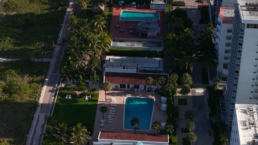 Revealing Drone Shot of South Beach Miami, Swimming Pool, Sandy Shore and Beachfront Buildings