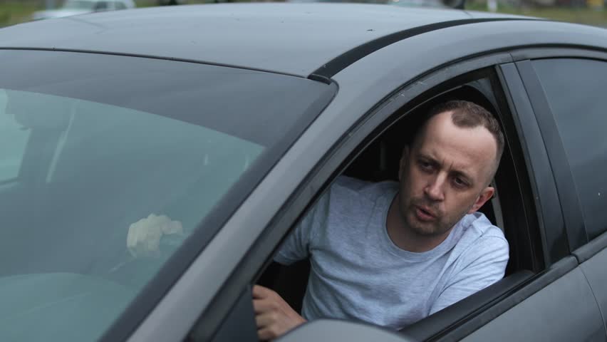 Road rage. Conflict. Man in a car. Slow motion video.High quality 4k footage