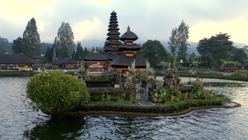 Aerial view of the iconic Ulun Danu Beratan Temple on the lake in Bali, Indonesia. Serene water and peaceful tropical surroundings.