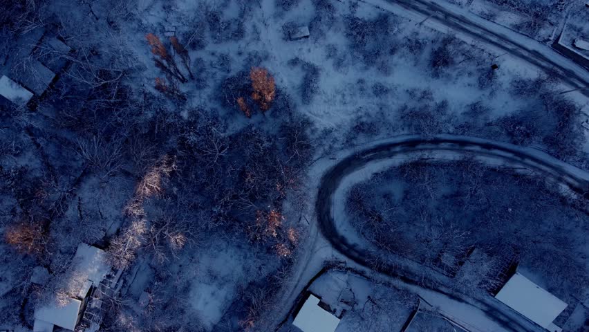 Aerial view of a winding road in the snowy mountains of Armenia during winter.