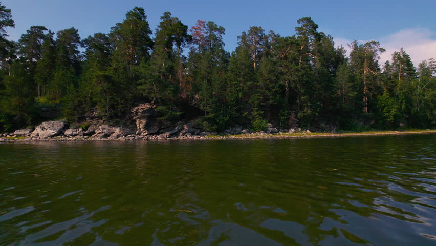 Scenic lake landscape with a rocky forested shore
