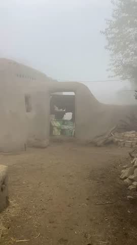 Traditional Mud House and Farm Animals in Heavy Foggy Morning - Rural Village Life.