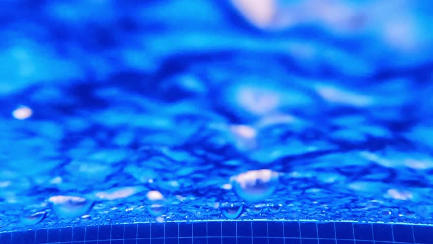 Slow motion of raindrops under and top of the swimming pool.