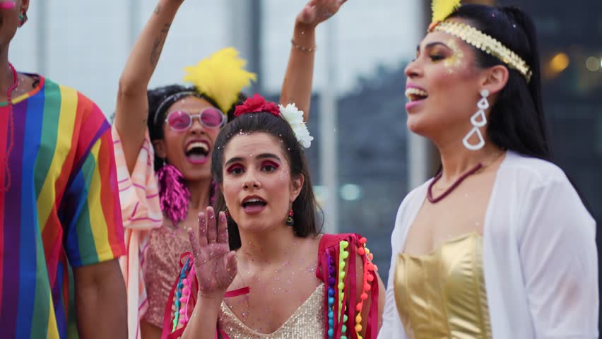 Joyful friends celebrating Brazilian Carnival in colorful costumes on a vibrant street. Happy group enjoying the festive energy of traditional Carnaval in Brazil