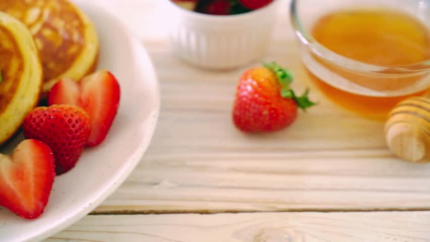 Fluffy souffle pancakes topped with fresh strawberries, perfect for a healthy breakfast or diet-friendly meal. A visually appealing concept highlighting nutritious ingredients, wellness, and gourmet breakfast presentation.