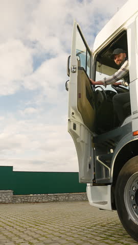 Professional truck driver sitting in his semi truck cabin