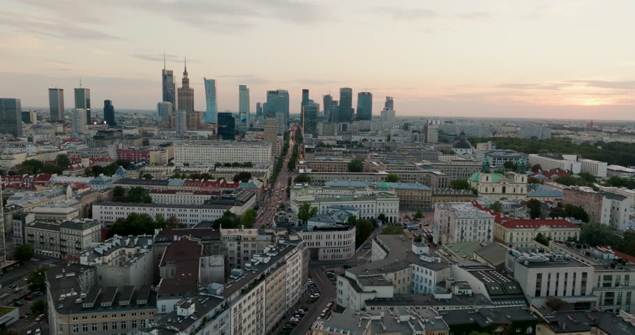 Aerial view of Warsaw Downtown Skyline with arterial city road. Urban panorama of busy traffic, ideal for establishing scenes, business, travel and European capital visuals. 4K drone zoom in shot