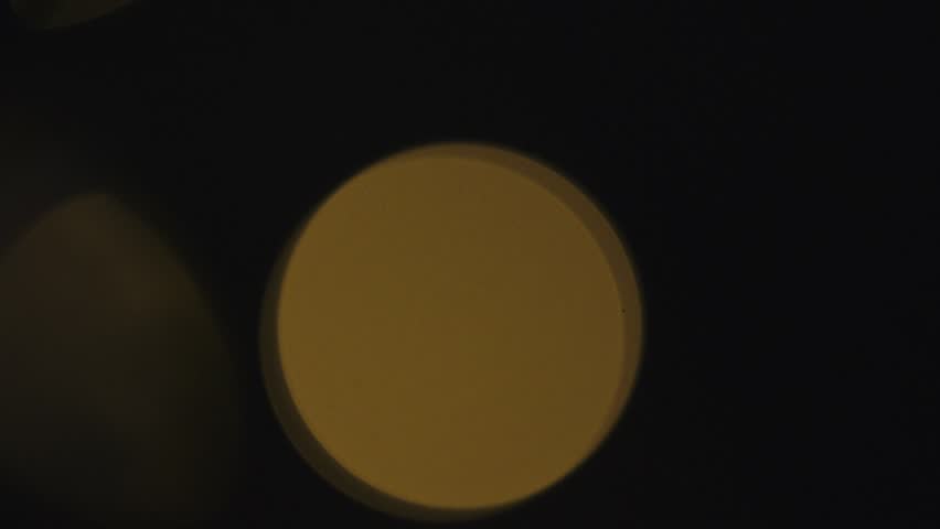 4k slow motion moving yellow particles. Abstract Christmas background. Blurry blinking lights. Generic graphic resources.