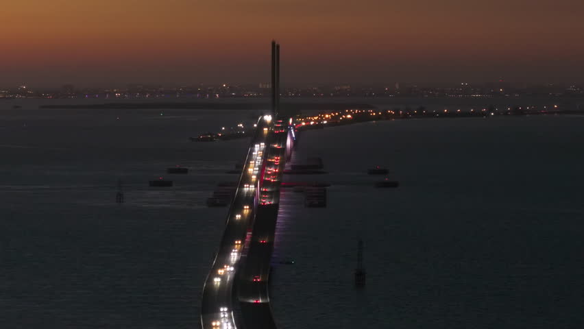 Aerial view of Sunshine Skyway Bridge over Tampa Bay in Florida with moving traffic at night. Concept of transportation infrastructure