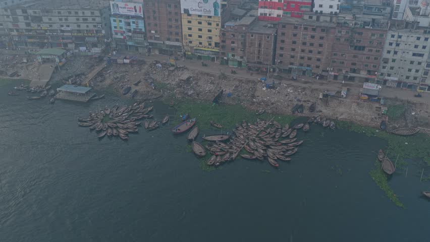 Rowboats moving through busy Buriganga River waterway in Dhaka city, Bangladesh