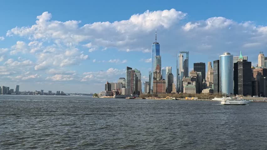 Sailing through New York Harbor with stunning views of the Manhattan skyline. Perfect for travel, tourism, urban lifestyle, and cityscape projects.