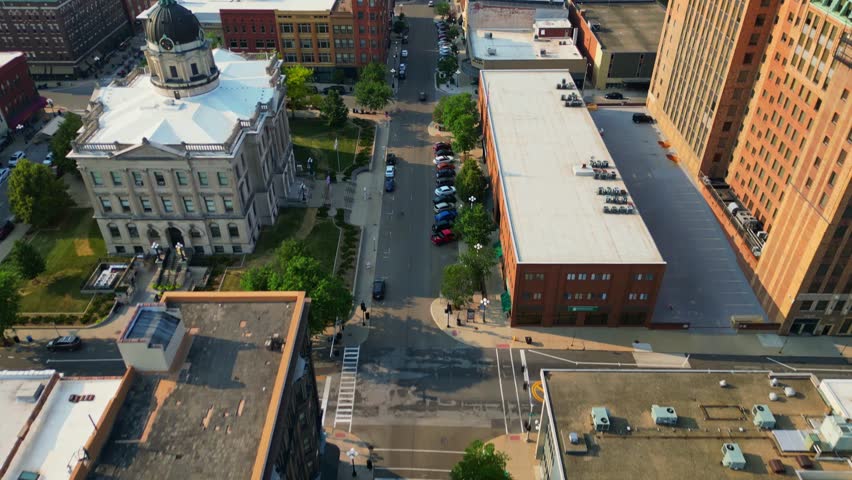 An impressive aerial view captures the vibrant downtown of Bloomington, Illinois, showcasing the historic McLean County Courthouse with its distinctive dome