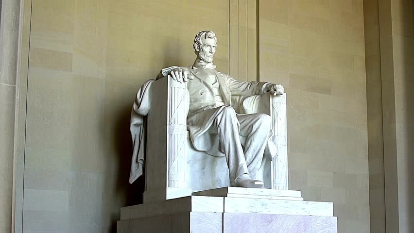 Majestic statue of Abraham Lincoln situated within Lincoln Memorial. Quiet morning atmosphere enhances reflection on history and leadership.
