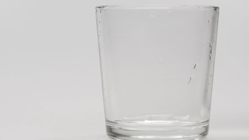 pouring mineral sparkling water in glass in white background Slow Motion Super Slow Motion Detail Shot of Ice Cubes crystals of pure water hygiene