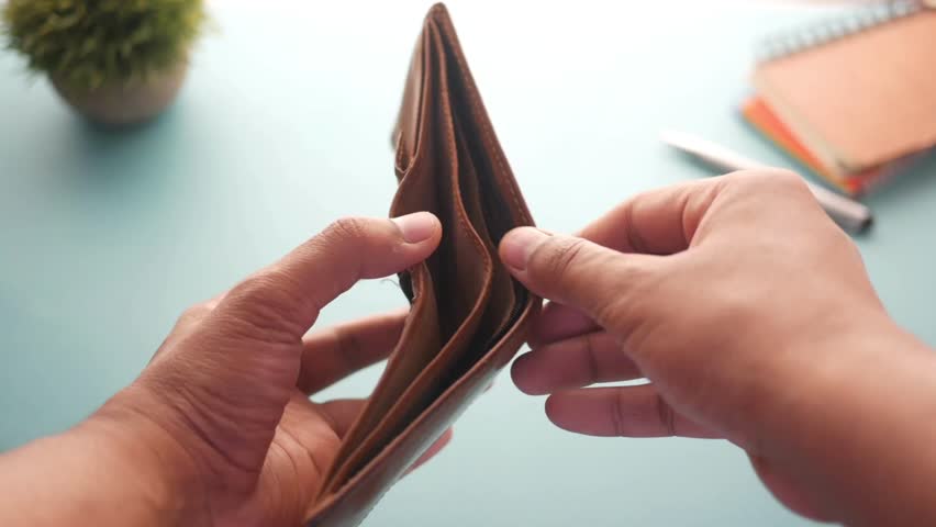 isolated background of person holding an empty wallet credit card debt expenses concept taxes bank