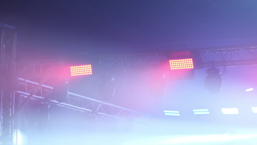 Concert Stage And Hall Illuminated By Colorful Lights And Mist