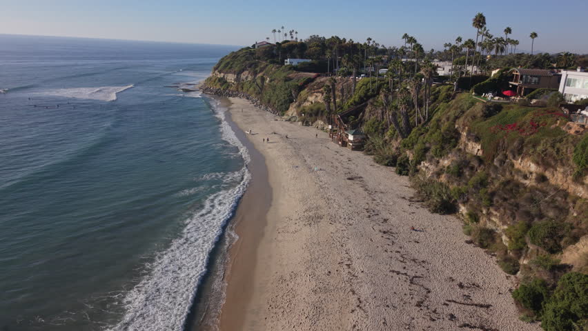 Swamis Beach in Encinitas, California. Drone 4k video of cliffs, sand, and ocean.