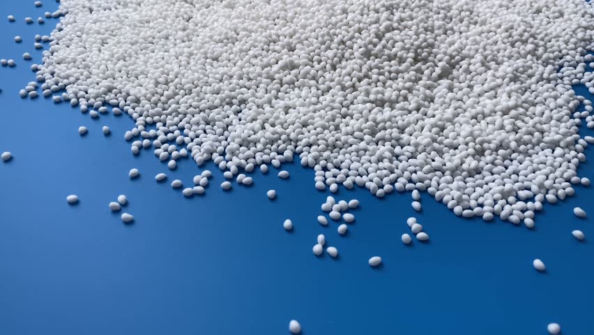 Plastic white granules are a raw material for industry. Concept: research, biochemistry, nature, pharmaceuticals.