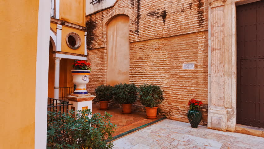 A traditional Andalusian patio with a marble floor, fountain and floors in Seville, Andalusia, Spain
