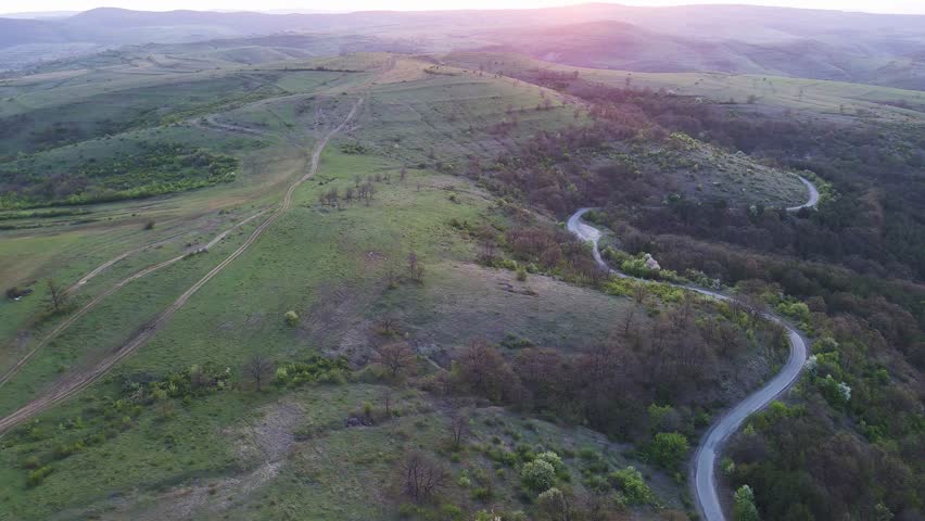A view from a height of the meadows and slopes of the Balkan Mountains under daylight in Bulgaria