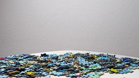 Stream of many colorful jigsaw puzzle pieces falling onto a table. Ideal for business, education, presentations and advertising visuals - Powered by Shutterstock - Get 15% off with code: PIKWIZARD15