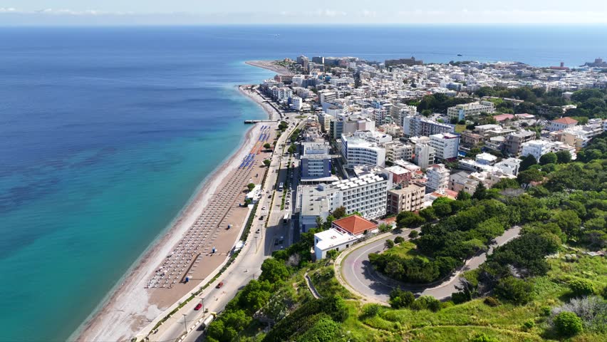 Aerial drone cinematic video of famous main sandy beaches of Rhodes island west coast called Akti Miaouli and Akti Kanari famous for luxury hotels and nice seaside restaurants, Dodecanese, Greece