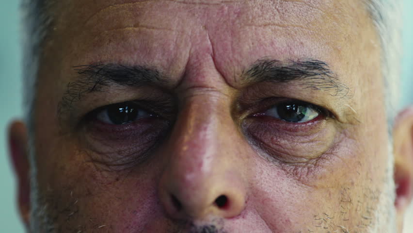 Extreme close up of weary middle aged man’s eyes showing fatigue and emotion, deep wrinkles and tired gaze reflecting life experience and quiet introspection