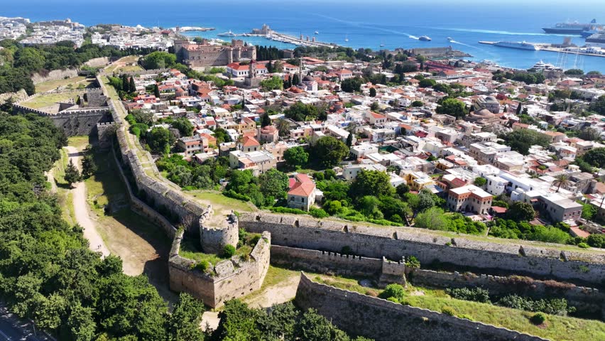 Aerial drone cinematic video of popular for tourists Medieval fortified old town of Rhodes island featuring nice restaurants and ancient sites an Unesco World Heritage, Dodecanese, Greece