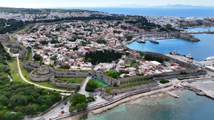 Aerial drone cinematic video of popular for tourists Medieval fortified old town of Rhodes island featuring nice restaurants and ancient sites an Unesco World Heritage, Dodecanese, Greece