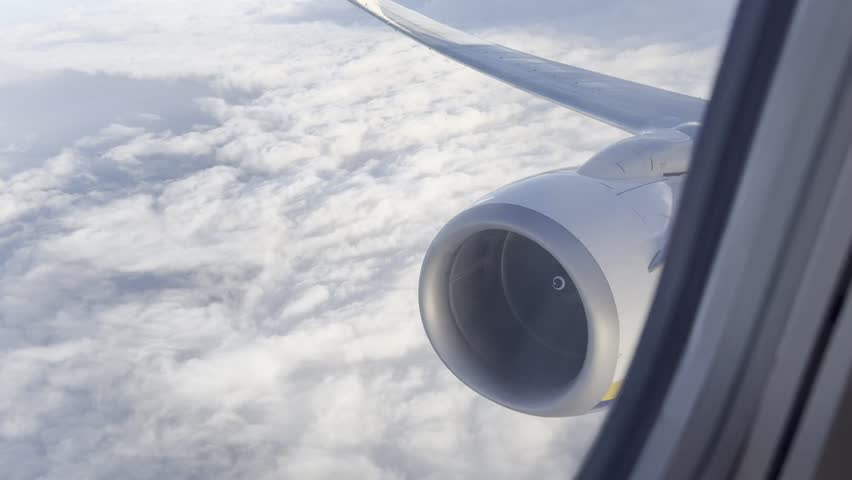 From the aeroplane a kind of a particularly view with clouds and aeroplane’s engine