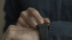 Close-up of a young man using a smartwatch, illustrating wearable technology, fitness tracking, notifications, and modern digital lifestyle. - Powered by Shutterstock - Get 15% off with code: PIKWIZARD15