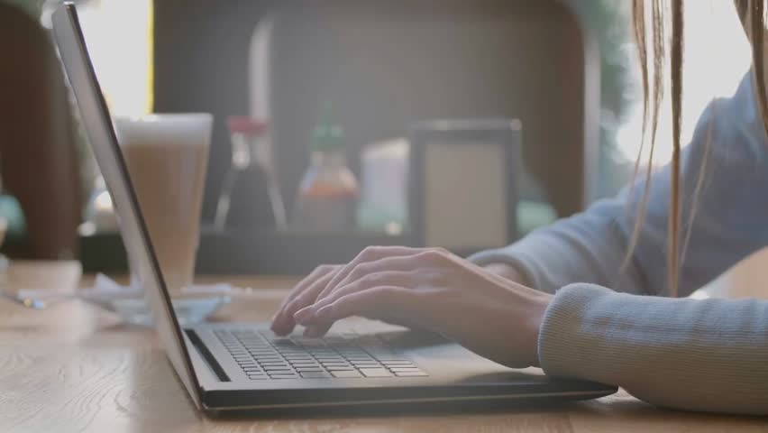 Close-up of a woman’s hands typing on a laptop in an office, highlighting digital work, professional tasks, business workflow, and modern office lifestyle.