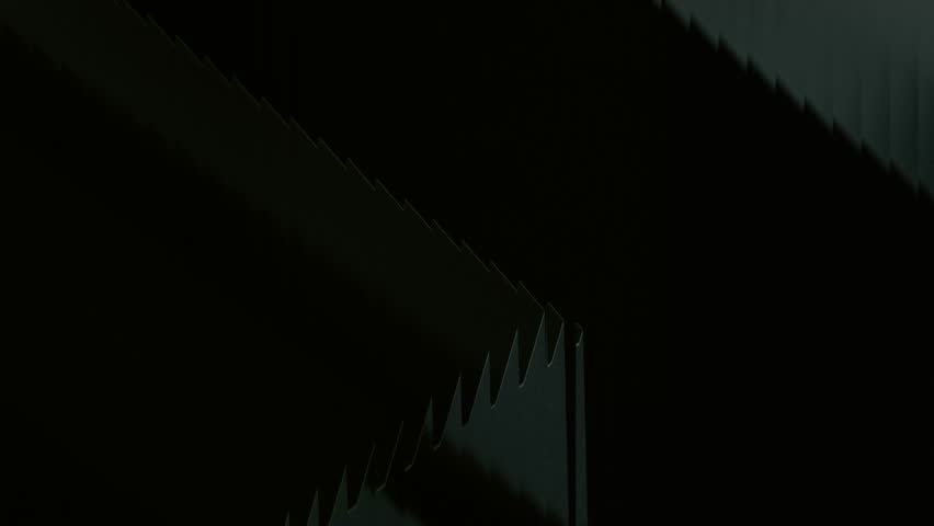 Close-up of sharp saw blades cutting through dark shadows, evoking a sense of power and precision.