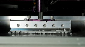Automated solder paste printer applying precise stencil deposits to a pcb for surface-mount assembly in an electronics manufacturing line, showcasing high-tech production process - Powered by Shutterstock - Get 15% off with code: PIKWIZARD15