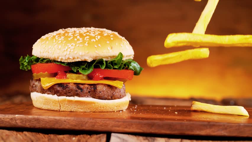Fast food beauty shot featuring hamburger with fresh lettuce, pickles, tomato, crispy french fries, and grilled kabab. Rich textures, appetizing styling, and clean composition make it ideal for food advertising, restaurant promos, and commercial visuals.