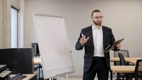 Bearded man in a suit presenting complex data and charts on a flip chart, teaching business concepts to professionals - Powered by Shutterstock - Get 15% off with code: PIKWIZARD15