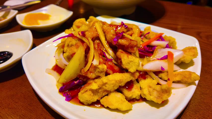 Sweet and sour sauce fried with pork tangsuyuk on dish in the restaurant
