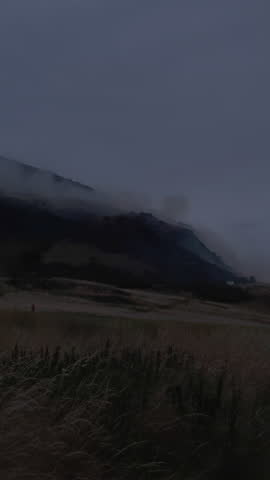 EDINBURGH, SCOTLAND, UK - AUGUST 10, 2025: Smoke rises from a fire on Arthur