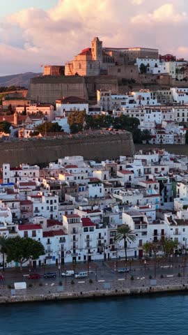 vertical video: Sunrise aerial view of Eivissa old historic town and fortress on Ibiza island, Balearic Islands, Spain, vacation in Ibiza, travel on Ibiza island. High quality 4k footage