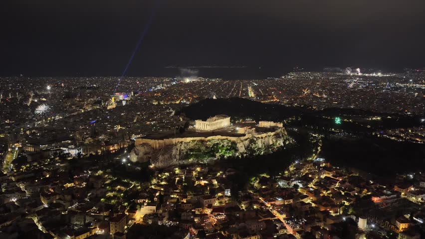 Aerial drone cinematic video of illuminated city of Athens historic centre during New Year