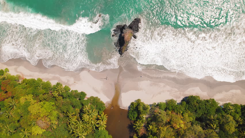 Aerial view of Manuel Antonio Espadilla Beach in Costa Rica showing ocean waves
